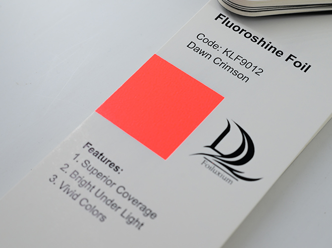 How does fluorescent foil differ from regular foil